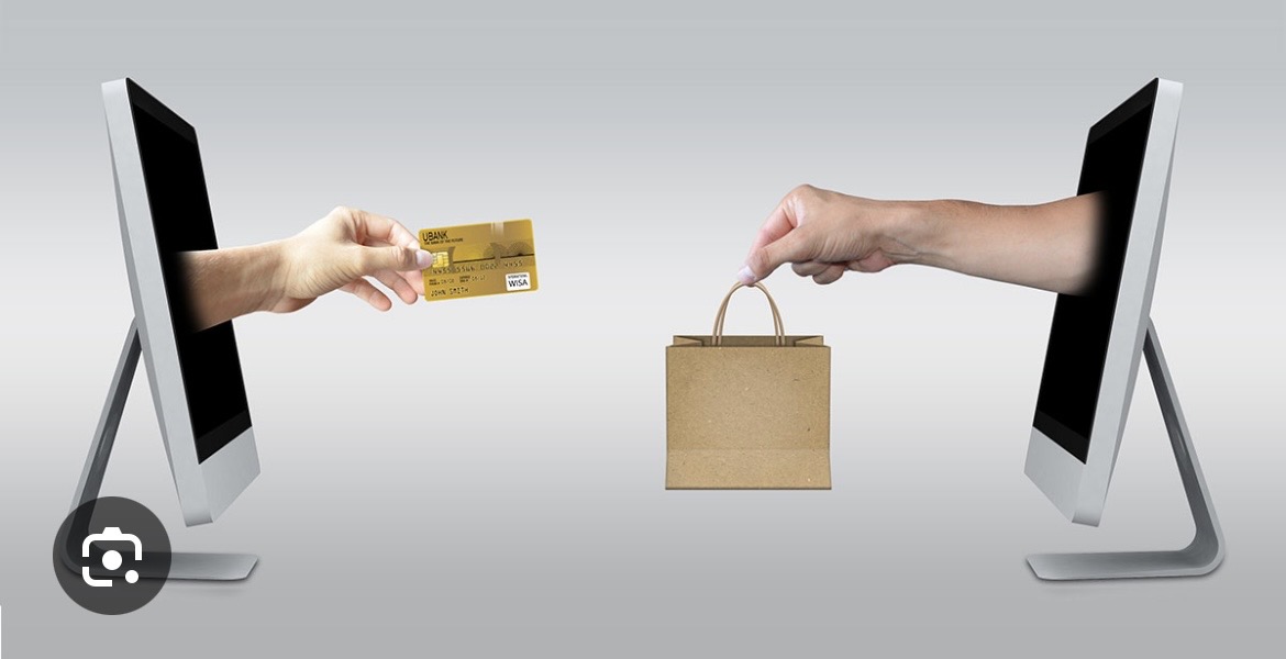 Two computer screens exchanging a payment card and a shopping bag